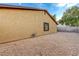 Home exterior showcasing textured stucco and gravel-covered yard with potential for low-maintenance landscaping at 520 Prince Alan Ct, Las Vegas, NV 89110