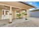 Inviting covered front porch with decorative support columns and stone landscaping at 520 Prince Alan Ct, Las Vegas, NV 89110