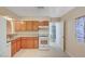 Functional kitchen featuring wooden cabinets, white appliances, and tiled flooring at 520 Prince Alan Ct, Las Vegas, NV 89110