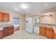 Updated kitchen with white appliances, wood cabinets, and a pass-through window at 520 Prince Alan Ct, Las Vegas, NV 89110