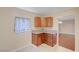 Charming kitchen with wooden cabinets, granite counters, and a glimpse into the living room at 520 Prince Alan Ct, Las Vegas, NV 89110