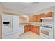 Well-lit kitchen boasting white appliances, wooden cabinets, and granite countertops at 520 Prince Alan Ct, Las Vegas, NV 89110