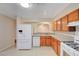 Bright kitchen featuring white appliances, wood cabinets, and granite countertops at 520 Prince Alan Ct, Las Vegas, NV 89110