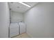 Laundry room features side-by-side washer and dryer with tiled floor at 520 Prince Alan Ct, Las Vegas, NV 89110