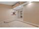 Open-concept living area with tile flooring and arched room divider at 520 Prince Alan Ct, Las Vegas, NV 89110