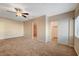 Spacious carpeted main bedroom featuring ceiling fan, closet, and an ensuite bathroom at 520 Prince Alan Ct, Las Vegas, NV 89110