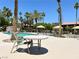 Community pool area featuring a table with lounge chairs and landscaping at 5383 Indian River Dr # 327, Las Vegas, NV 89103