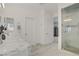 Bright bathroom features marble countertops, dual sinks, walk-in shower with glass enclosure, and modern fixtures at 5742 Shadow Bend Dr, Las Vegas, NV 89135