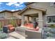 Cozy patio with modern fire pit, comfortable seating and desert landscaping creating a relaxing outdoor space at 5742 Shadow Bend Dr, Las Vegas, NV 89135