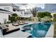 A resort style backyard features a pool and spa surrounded by lush landscaping at 60 Innisbrook Ave, Las Vegas, NV 89113