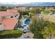 Aerial shot highlighting the private backyard pool, dining, and barbecue area, and lush tropical landscaping at 60 Innisbrook Ave, Las Vegas, NV 89113