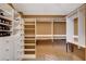 Organized walk-in closet features custom shelving, hanging rods, and a shoe rack for optimal storage at 60 Innisbrook Ave, Las Vegas, NV 89113