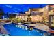 Nighttime home exterior, featuring a large pool, inviting lights, and spacious backyard at 60 Innisbrook Ave, Las Vegas, NV 89113