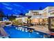 Stunning home exterior at night, showcasing a sparkling pool and lush landscaping at 60 Innisbrook Ave, Las Vegas, NV 89113