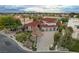Expansive estate with a three-car garage, lush landscaping, and a meticulously paved driveway at 60 Innisbrook Ave, Las Vegas, NV 89113