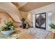 Elegant foyer with a curved staircase, decorative rug, and stylish lighting fixtures at 60 Innisbrook Ave, Las Vegas, NV 89113