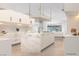 Bright, remodeled kitchen features marble island, herringbone backsplash and white cabinets at 60 Innisbrook Ave, Las Vegas, NV 89113