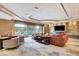 Living room featuring a fireplace, lounge area, and large windows at 60 Innisbrook Ave, Las Vegas, NV 89113