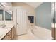 Bright bathroom featuring white cabinets and a tub with shower at 605 Devonhall St # 201, Las Vegas, NV 89145