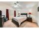 Bedroom featuring neutral walls, ceiling fan, carpet and stylish furniture and decor at 605 Devonhall St # 201, Las Vegas, NV 89145