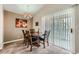 Cozy dining room featuring a chandelier, large sliding glass door to patio, and seating for six at 605 Devonhall St # 201, Las Vegas, NV 89145