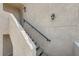 Close up of entry steps highlighting the textured stucco and a dark railing leading to the front door at 605 Devonhall St # 201, Las Vegas, NV 89145