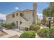 Inviting two-story condo showcasing lovely landscaping and a pathway leading to the entrance at 605 Devonhall St # 201, Las Vegas, NV 89145