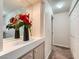 Hallway features a large mirror, decorative flowers, and access to multiple rooms at 605 Devonhall St # 201, Las Vegas, NV 89145