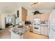 Well-equipped kitchen featuring light wood cabinetry, granite countertops, and modern appliances at 605 Devonhall St # 201, Las Vegas, NV 89145