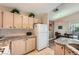 Bright kitchen with white appliances, tile backsplash, granite counters, and plenty of cabinet space at 605 Devonhall St # 201, Las Vegas, NV 89145
