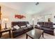 Spacious living room featuring a comfortable leather sofa set, complemented by tasteful decor at 605 Devonhall St # 201, Las Vegas, NV 89145