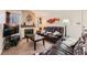 Comfortable living room featuring a cozy fireplace and a large, leather sofa set at 605 Devonhall St # 201, Las Vegas, NV 89145