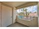 Cozy balcony overlooks the community pool surrounded by palm trees and lush landscaping at 605 Devonhall St # 201, Las Vegas, NV 89145