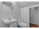 Neutral toned half bathroom with a sink and toilet at 6325 Orions Tool St, North Las Vegas, NV 89031