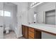 Bathroom featuring a vanity with drawers, a large mirror, and a separate toilet/shower area at 6325 Orions Tool St, North Las Vegas, NV 89031