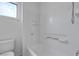 Bathroom showcasing a white tiled shower and tub combination with a window for natural light at 6325 Orions Tool St, North Las Vegas, NV 89031