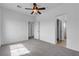 A bedroom with carpet, a ceiling fan, and multiple entryways to other parts of the house at 6325 Orions Tool St, North Las Vegas, NV 89031