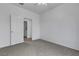 A bright bedroom with plush carpeting, a ceiling fan, and a view to the next room at 6325 Orions Tool St, North Las Vegas, NV 89031