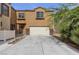 Charming townhouse showcasing a two-car garage and desert landscaping at 6325 Orions Tool St, North Las Vegas, NV 89031
