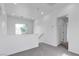 Carpeted hallway with white walls, recessed lighting, a window, and doorways to other rooms at 6325 Orions Tool St, North Las Vegas, NV 89031