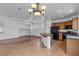Open layout kitchen with a breakfast bar, hardwood floors, and modern appliances at 6325 Orions Tool St, North Las Vegas, NV 89031