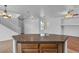 Open-concept kitchen featuring an island, breakfast bar, and stainless appliances at 6325 Orions Tool St, North Las Vegas, NV 89031
