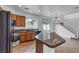 Bright kitchen with an island, modern appliances, and a staircase view at 6325 Orions Tool St, North Las Vegas, NV 89031