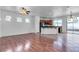 Open-concept living area with hardwood floors, a ceiling fan, and natural light at 6325 Orions Tool St, North Las Vegas, NV 89031