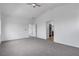 Spacious main bedroom with carpeted floors, ceiling fan, and open doorways at 6325 Orions Tool St, North Las Vegas, NV 89031