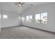 Spacious main bedroom with carpeted floors, ceiling fan, and multiple windows at 6325 Orions Tool St, North Las Vegas, NV 89031