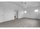 Spacious main bedroom with carpeted floors, ceiling fan, and views from multiple windows at 6325 Orions Tool St, North Las Vegas, NV 89031