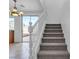 Bright staircase features carpeted stairs and a white banister leading to the upper level at 6325 Orions Tool St, North Las Vegas, NV 89031