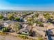 Wide aerial shot of a desert neighborhood, showcasing a beautiful single-Gathering home at 669 Elliot Peak Ave, Las Vegas, NV 89183