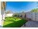 A backyard featuring new low-maintenance synthetic turf and desert landscaping at 669 Elliot Peak Ave, Las Vegas, NV 89183